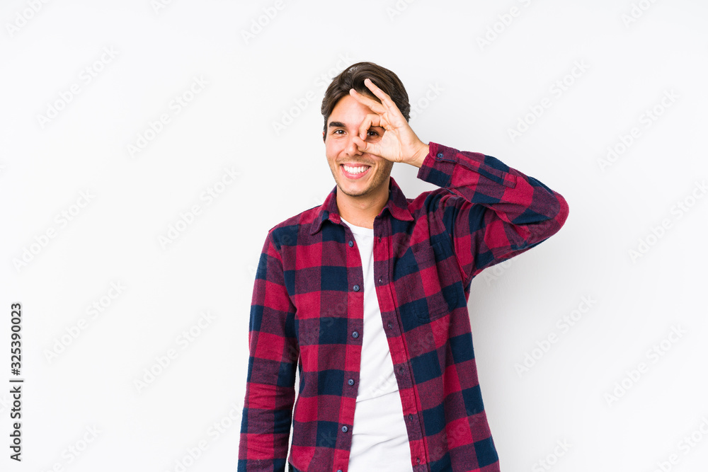 Young caucasian man posing in a pink background isolated excited keeping ok gesture on eye. Young caucasian man posing in a pink background isolated excited keeping ok gesture on eye.
