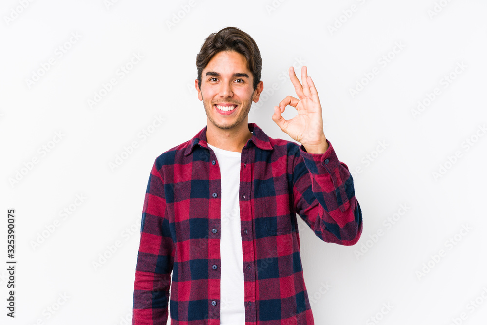 Young caucasian man posing in a pink background isolated cheerful and confident showing ok gesture. Young caucasian man posing in a pink background isolated cheerful and confident showing ok gesture.