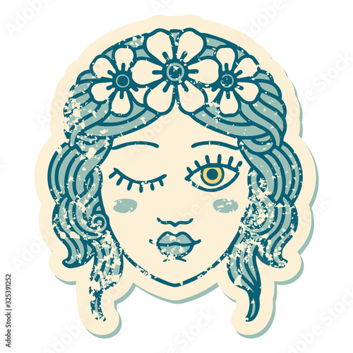 distressed sticker tattoo style icon of a maidens face winking