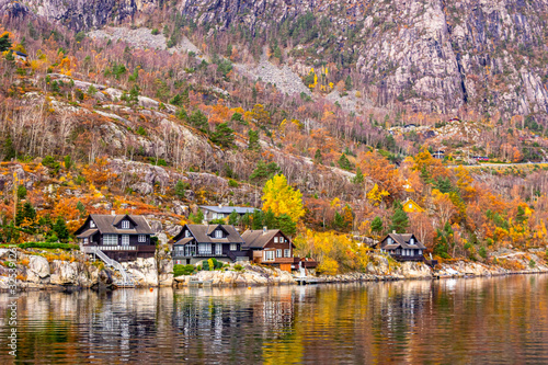 Magical waterfront in autumn with colourful trees that reminds of an Indian Summer in Lysefjord, Norway