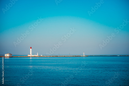 Vorontsov Lighthouse in the gulf of Odessa, Ukraine. Beautiful sunny day landscape with sea skyline. Amazing city panorama with blue water and beacon, pharos, seamark.