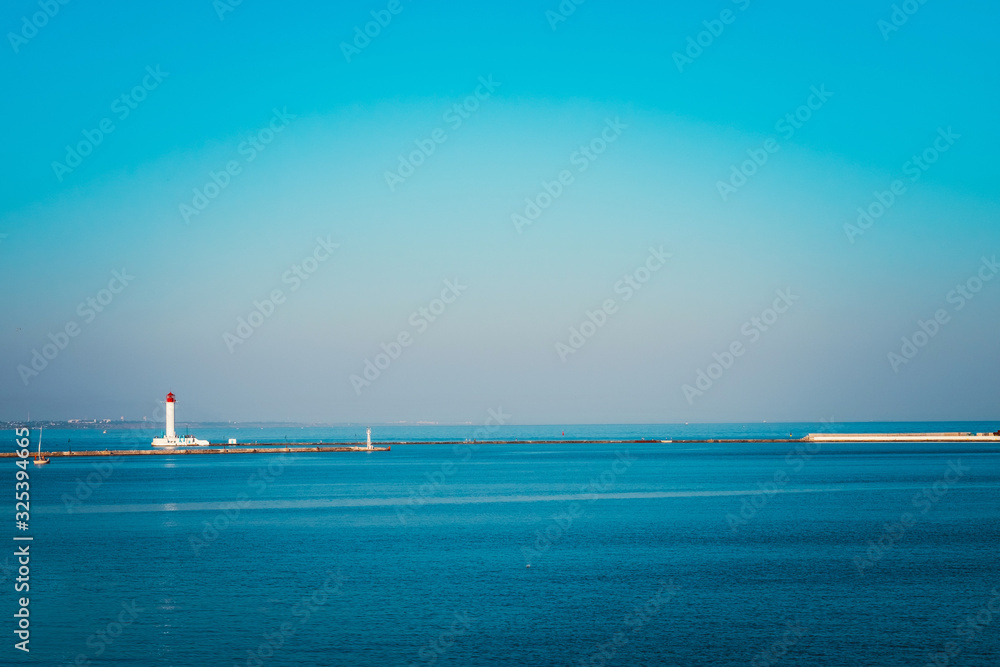 Vorontsov Lighthouse in the gulf of Odessa, Ukraine. Beautiful sunny day landscape with sea skyline. Amazing city panorama with blue water and beacon, pharos, seamark. Vorontsov Lighthouse in the gulf of Odessa, Ukraine. Beautiful sunny day landscape with sea skyline. Amazing city panorama with blue water and beacon, pharos, seamark.