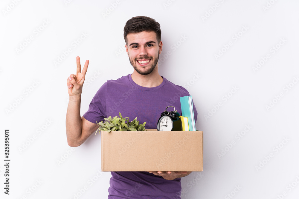 Young caucasian man moving a new home isolated showing number two with fingers. Young caucasian man moving a new home isolated showing number two with fingers.