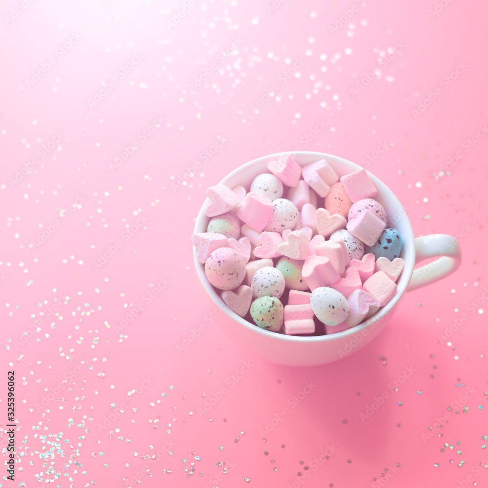 Tasty easter sweets in a cup on a pink background close-up. Tasty easter sweets in a cup on a pink background close-up.