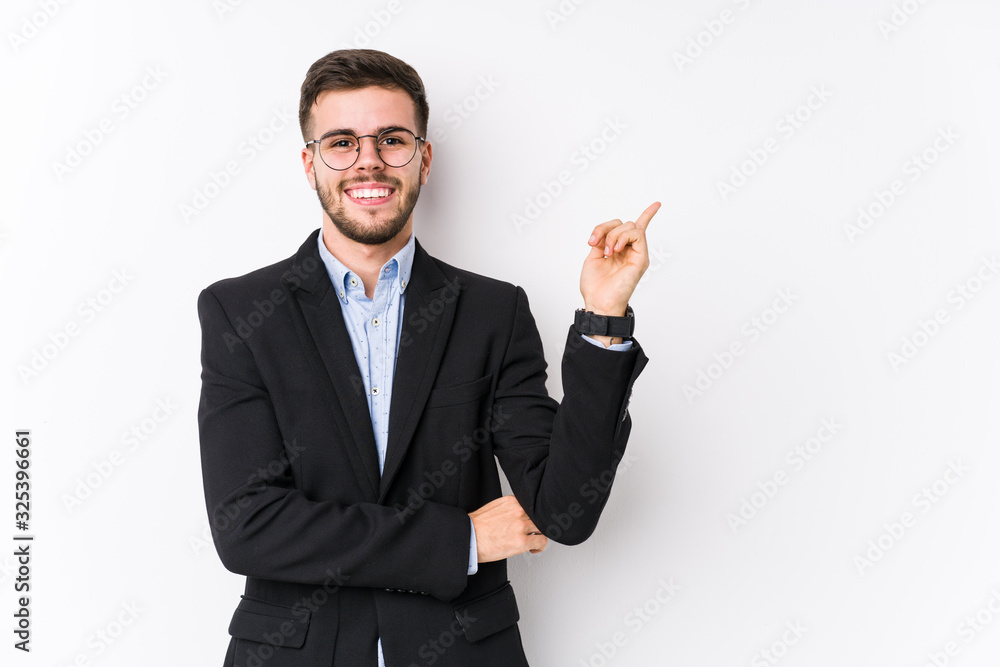 Young caucasian business man posing in a white background isolated Young caucasian business man smiling cheerfully pointing with forefinger away. Young caucasian business man posing in a white background isolated Young caucasian business man smiling cheerfully pointing with forefinger away.