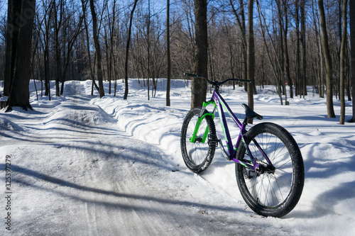 the bike stands in the background of dirt jumping in winter