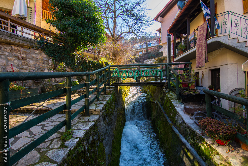 Water stream in Agoriani or Eptalofos village, a winter destination near Parnassos mountain in Greece