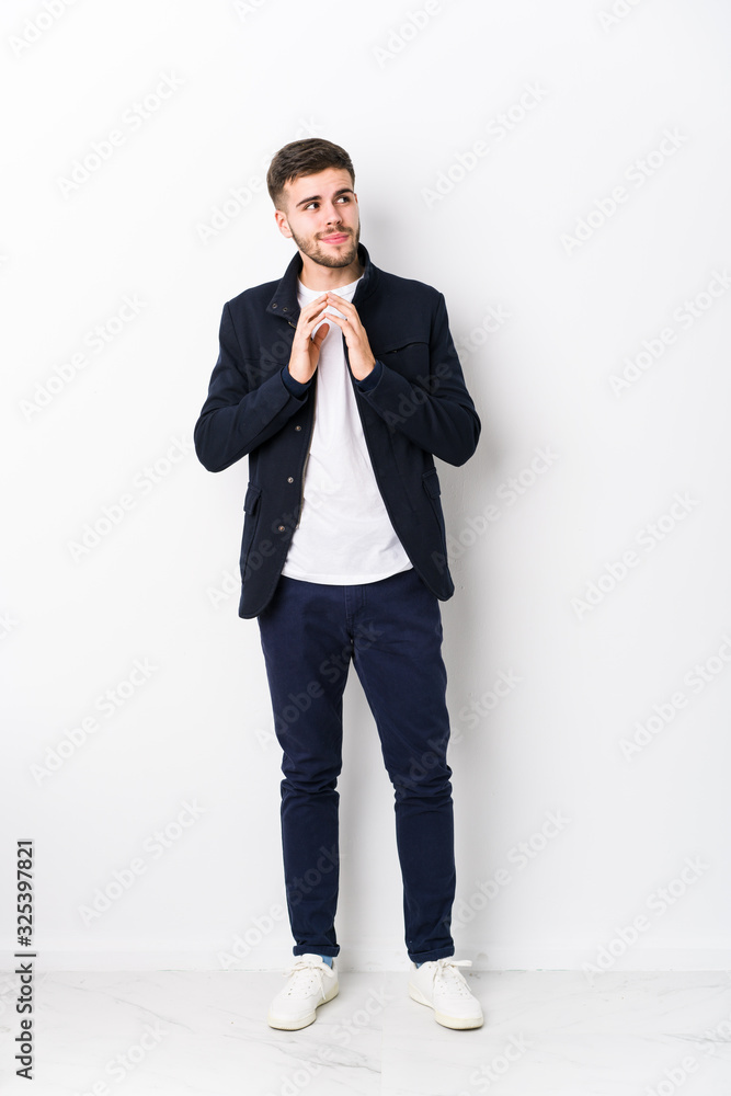 Full body young caucasian man isolated making up plan in mind, setting up an idea. Full body young caucasian man isolated making up plan in mind, setting up an idea.