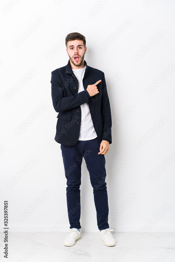 Full body young caucasian man isolated pointing to the side Full body young caucasian man isolated pointing to the side