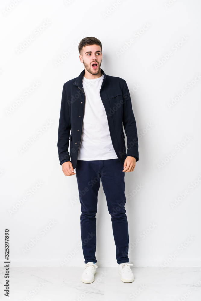 Full body young caucasian man isolated being shocked because of something she has seen. Full body young caucasian man isolated being shocked because of something she has seen.