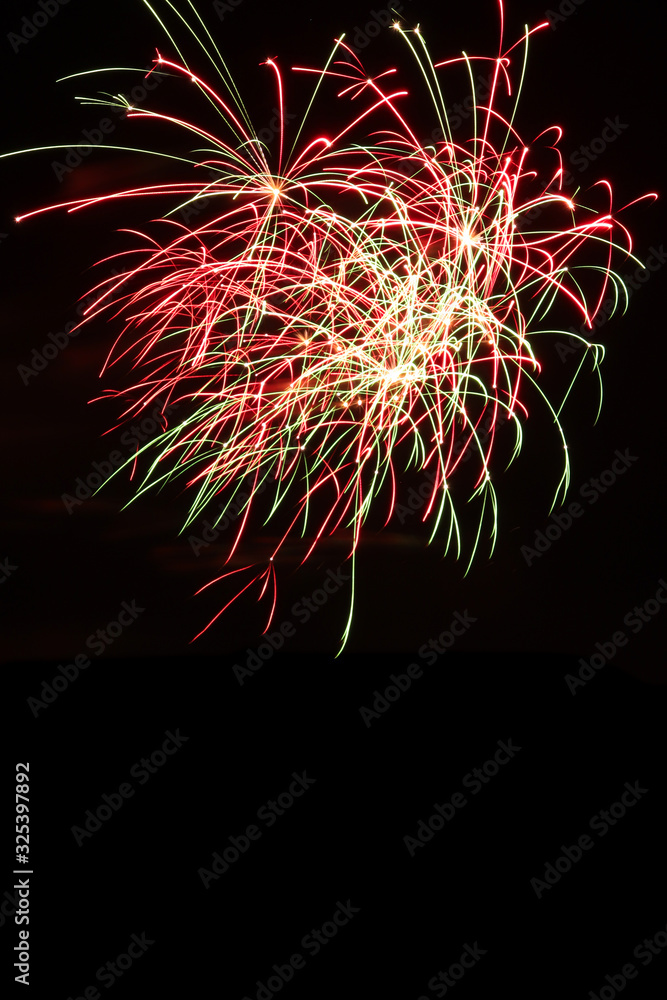 Streaks of red and green fireworks Streaks of red and green fireworks