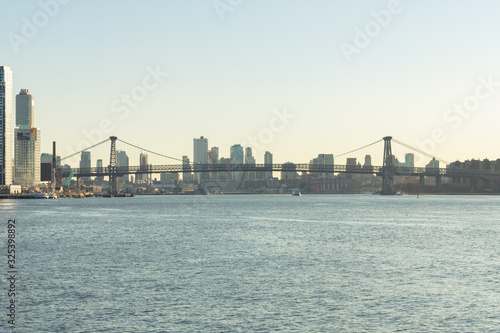 Williamsburg Bridge connecting Manhattan to Brooklyn New York over the East River before Sunset © James