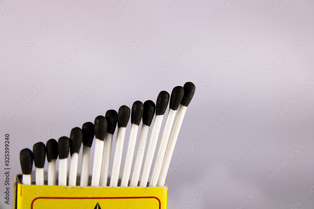 A creative concept of a wax match box with with stick and black head A creative concept of a wax match box with with stick and black head
