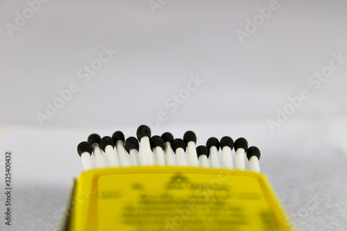 A creative concept of a wax match box with with stick and black head 