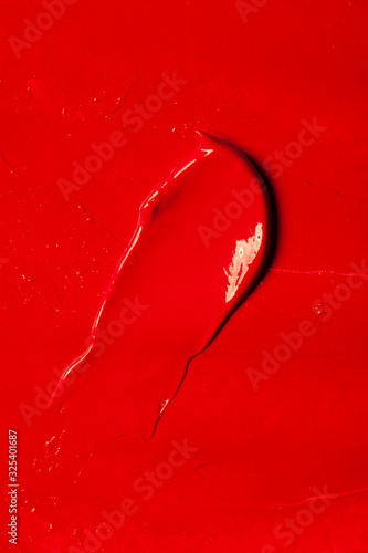 Beautiful photo of red lipstick, texture of red lipstick on a white background close-up.