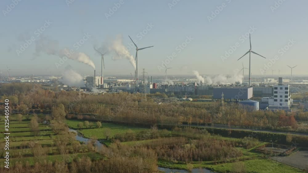 Evergem Belgium Aerial v1 Flying over fields towards wind turbines and industrial area - November 2019 Evergem Belgium Aerial v1 Flying over fields towards wind turbines and industrial area - November 2019