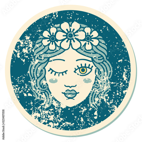 distressed sticker tattoo style icon of a maidens face winking