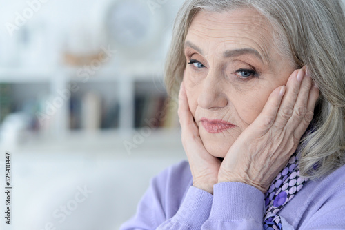 Close up portrait of tired senior woman