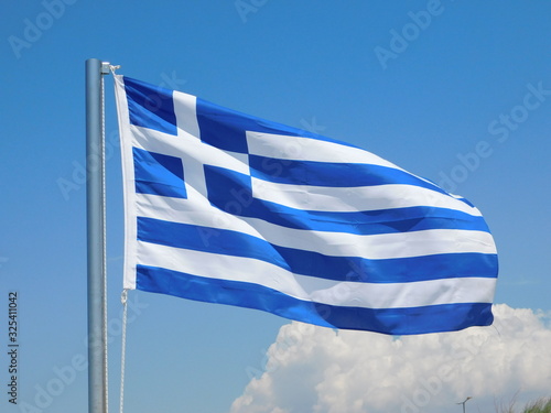 A blue and white Greek flag waiving in the wind