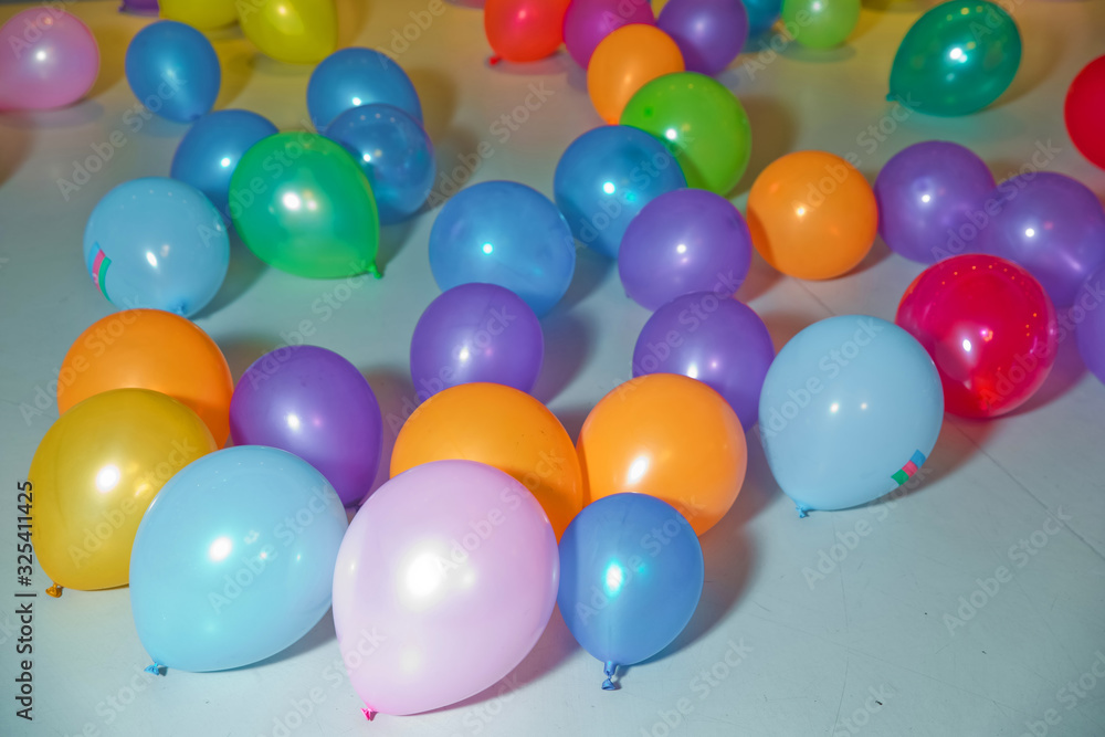 Flat lay of colorful balloons . holiday, children's party, a games room, a box filled with small colored balls . Different color balloons on the floor . Flat lay of colorful balloons . holiday, children's party, a games room, a box filled with small colored balls . Different color balloons on the floor .