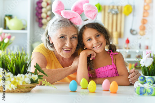 Senior grandmother and granddaughter with Easter eggs