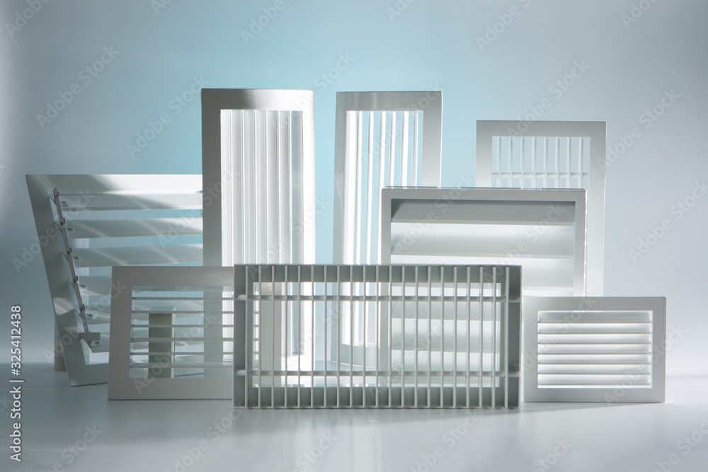 White ventilation grilles of different shapes and sizes. Demonstration of industrial ventilation