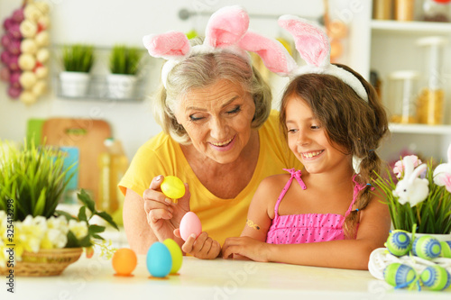 Senior grandmother and granddaughter with Easter eggs