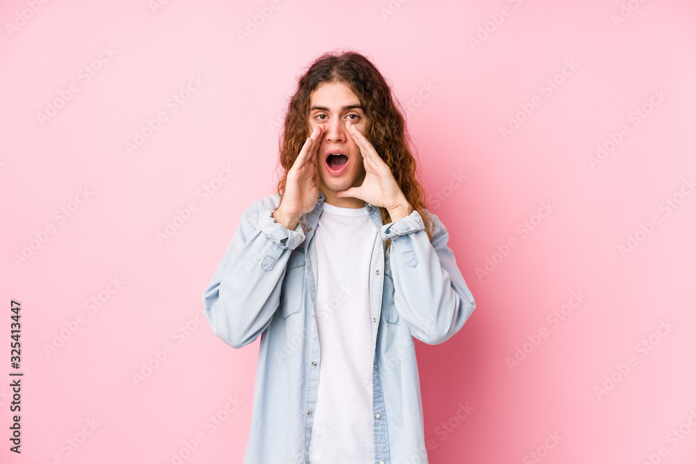 Long hair man posing isolated shouting excited to front. Long hair man posing isolated shouting excited to front.