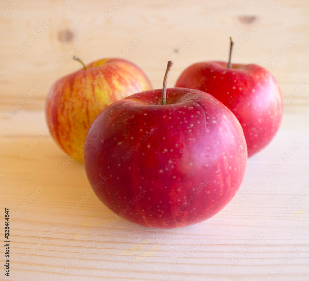 red tasty Sicilian apples on the on the wooden background, top view. Healthy lifestyle, vitamins and Mediterranean diet. red tasty Sicilian apples on the on the wooden background, top view. Healthy lifestyle, vitamins and Mediterranean diet.