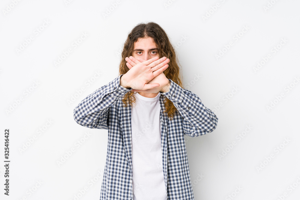 Young long hair man posing isolated doing a denial gesture Young long hair man posing isolated doing a denial gesture