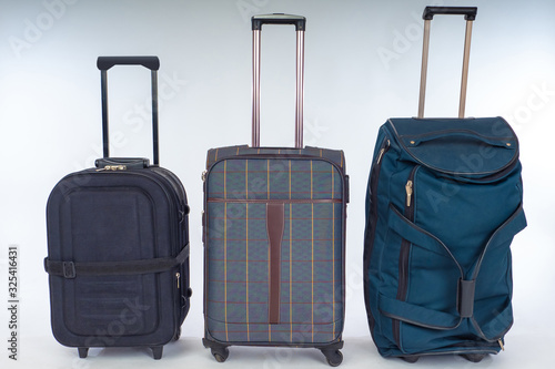 Suitcases and a bag on whee...