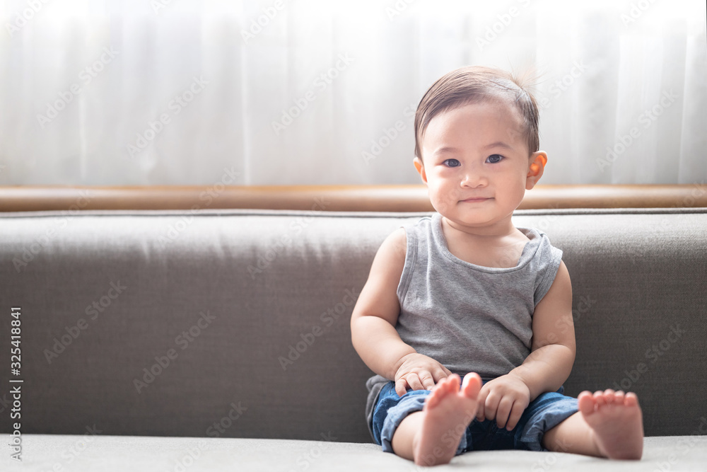 Asian baby boy sitting on sofa, copy space for writing articles. Asian baby boy sitting on sofa, copy space for writing articles.