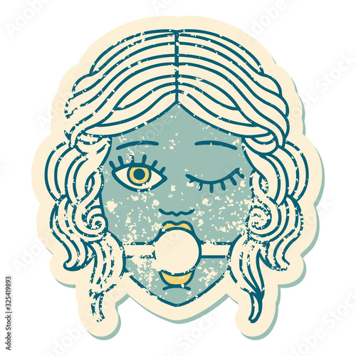 distressed sticker tattoo style icon of winking female face with ball gag