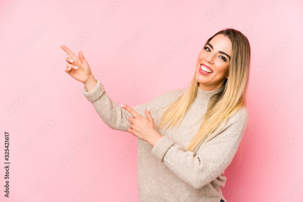 Middle age woman over isolated background excited pointing with forefingers away. Middle age woman over isolated background excited pointing with forefingers away.