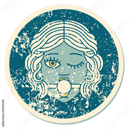 distressed sticker tattoo style icon of winking female face with ball gag