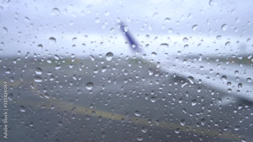 Slow motion rainy airplane wing from the interior window Slow motion rainy airplane wing from the interior window