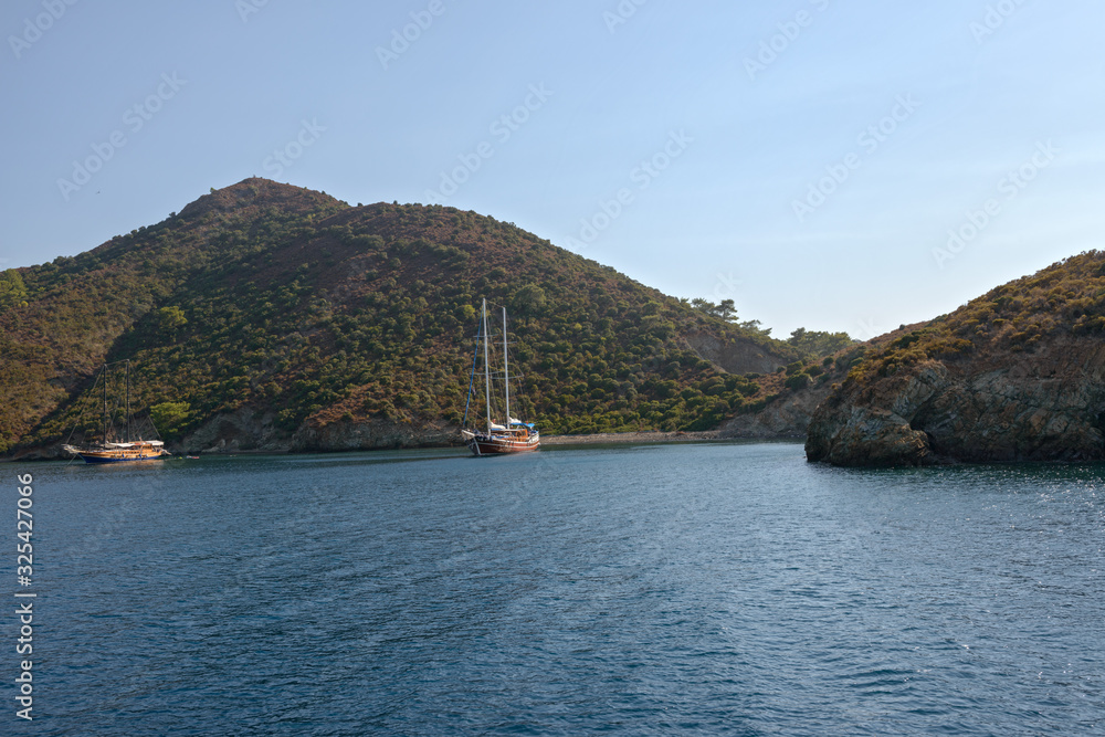 Seascape of Fethiye bay hilly islands with yachts, Turkey.