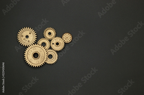 plastic golden gears on gray background