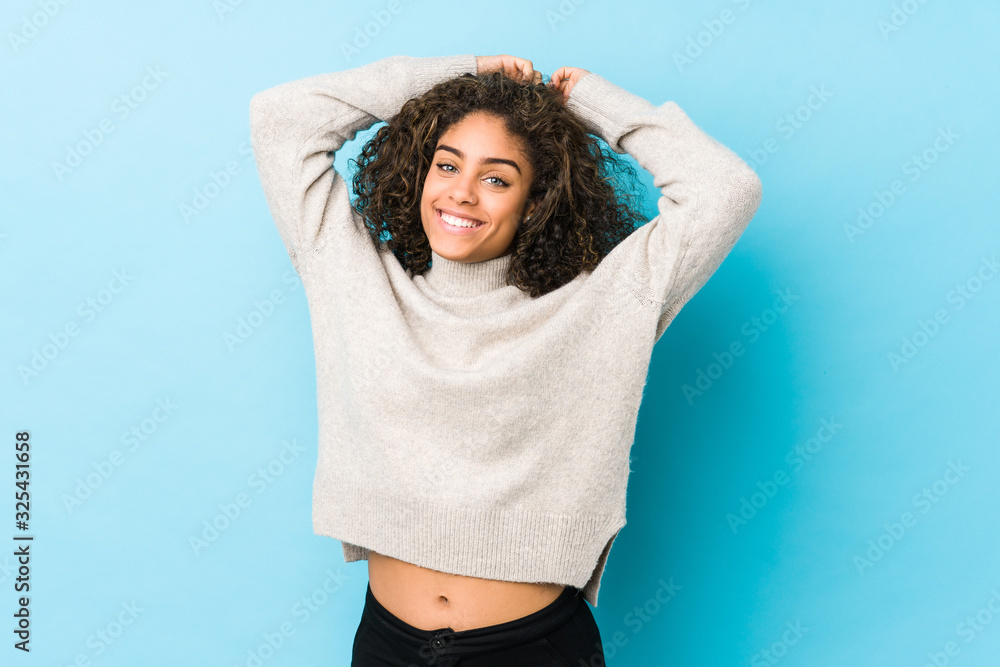 Young african american curly hair woman stretching arms, relaxed position. - obrazy, fototapety, plakaty 