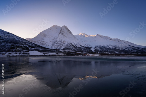 Winter Fugltinden mountain with reflection in Northern Norway