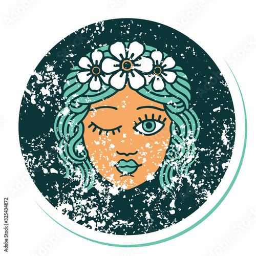 distressed sticker tattoo style icon of a maidens face winking