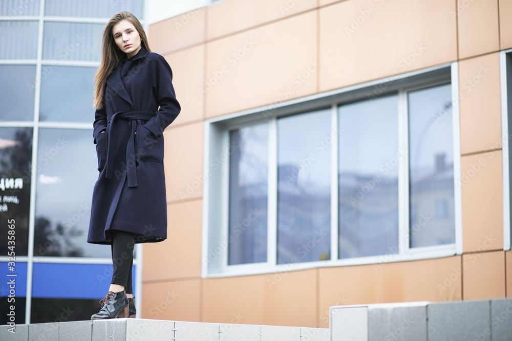 Beautiful girl in a coat in business downtown Beautiful girl in a coat in business downtown