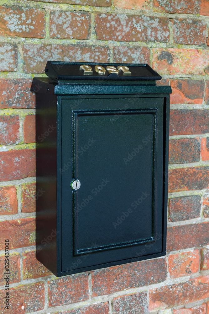 Vintage letterbox on brick wall, UK