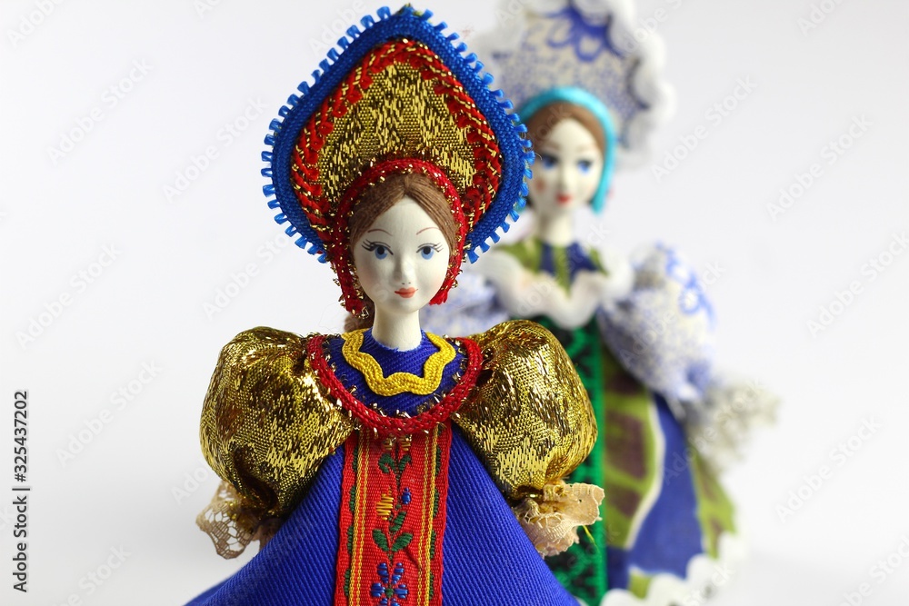 Two dolls in national Russian clothes. Sundress, kokoshnik. Light background.