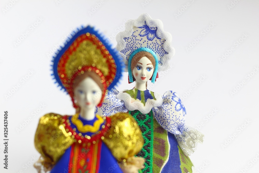 Two dolls in national Russian clothes. Sundress, kokoshnik. Light background. Two dolls in national Russian clothes. Sundress, kokoshnik. Light background.