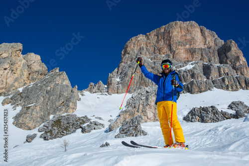 Skier stand on slope in winter mountains photo