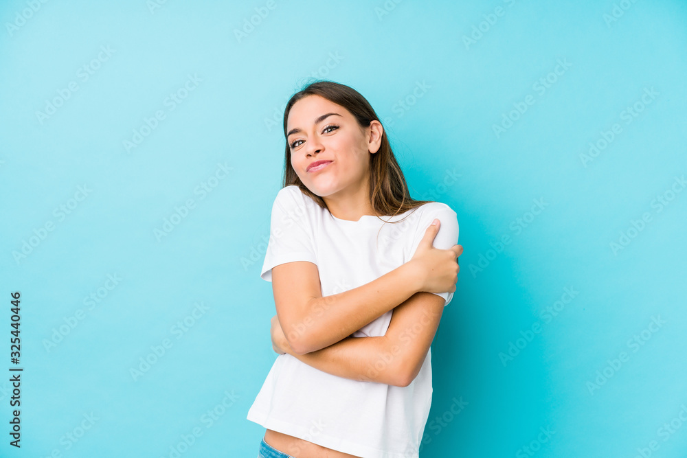 Young caucasian woman isolated hugs, smiling carefree and happy. Young caucasian woman isolated hugs, smiling carefree and happy.