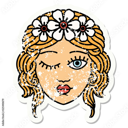 traditional distressed sticker tattoo of a maidens face winking