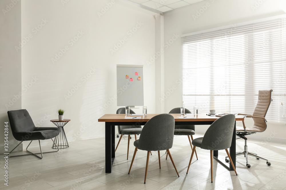 Simple office interior with large table and chairs