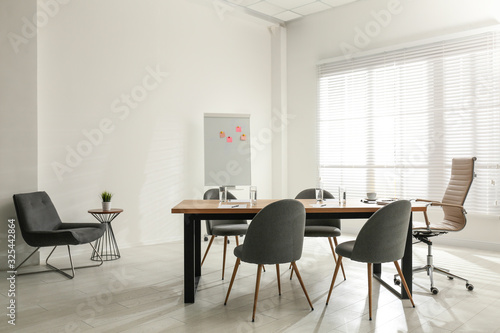 Simple office interior with large table and chairs © New Africa